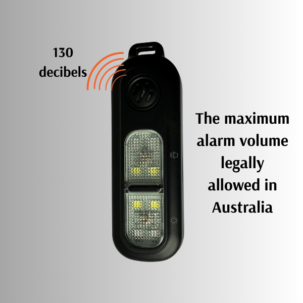 Personal  alarm device with LED lights, labeled with 130 decibel rating and text about legal alarm volume in Australia.