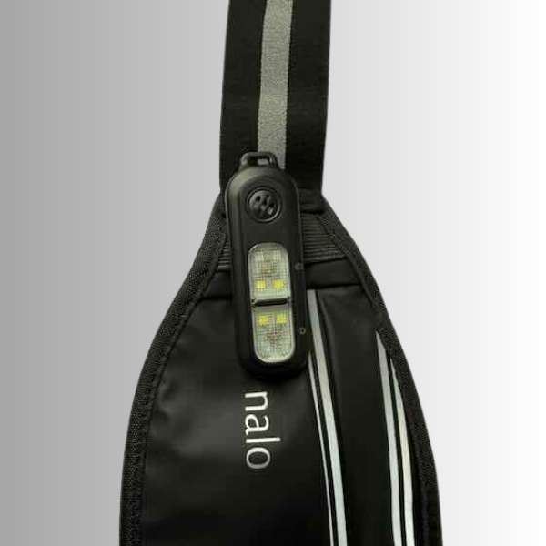 Black reflective waist bag with clip on personal safety alarm and a visible brand logo 'nalo' on a gray background