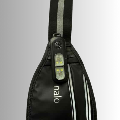 Black reflective waist bag with clip on personal safety alarm and a visible brand logo 'nalo' on a gray background